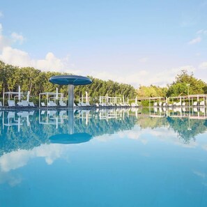 季节性开放的室外游泳池，09:00 至 19:00 开放，池畔遮阳伞，日光浴躺椅