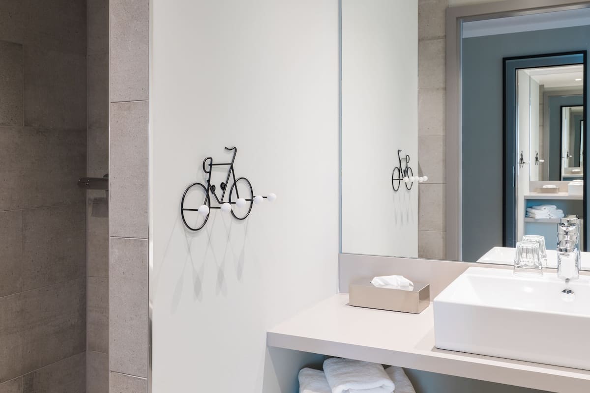 shower, hair dryer, slippers, towels