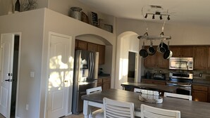 A modern kitchen with stainless steel appliances, wooden cabinets, and a central island. - *** GORGEOUS DESERT GETAWAY WITH HEATED  POOL NEAR THE DUKE GOLF COURSE*** (Maricopa)