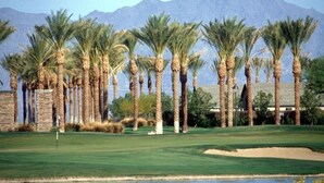 A golf course with palm trees and a mountain backdrop. - *** GORGEOUS DESERT GETAWAY WITH HEATED  POOL NEAR THE DUKE GOLF COURSE*** (Maricopa)