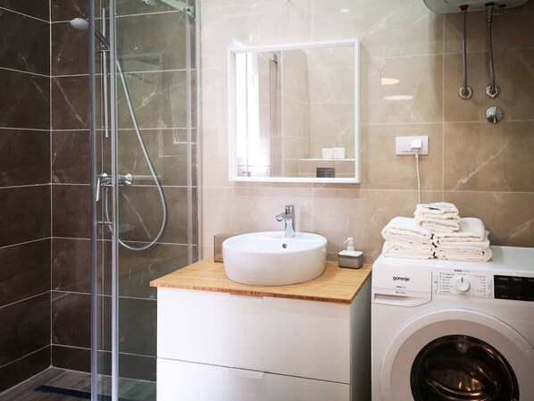 Shower, hair dryer, towels, soap