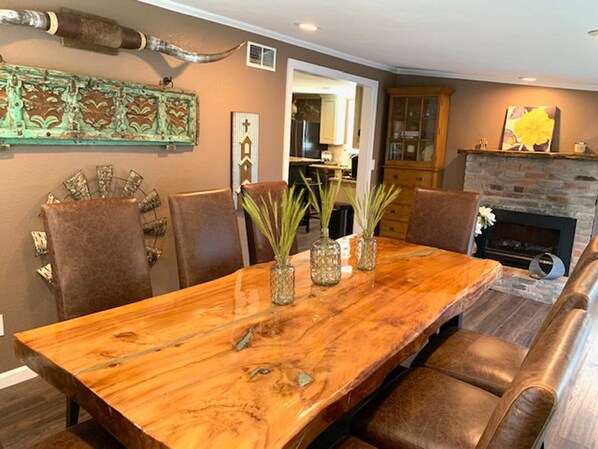 A dining area with a wooden table, chairs, and decorative vases.