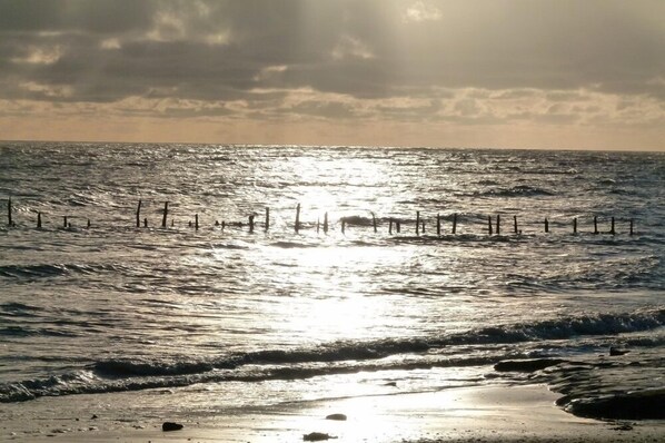 Enjoy a serene beach experience with gentle waves lapping at the shore.