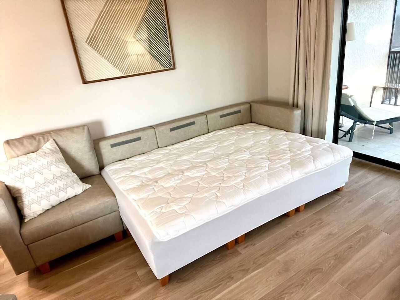 A modern room with a sofa and a large bed.