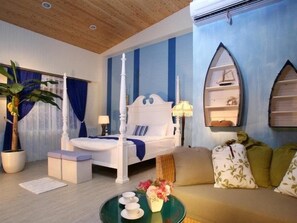 A bedroom with a four-poster bed, a sofa, a coffee table with cups and flowers, and a potted plant. - DeerStar Meihua Lake B&B (Dongshan)