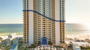 A high-rise hotel with multiple balconies, a beach view, and a water slide. - Gulf Coast Getaway w/ Balcony & Resort Amenities! (Panama City Beach)