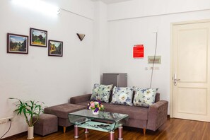 Relax in this stylish living room with a sofa, coffee table, and potted plant.