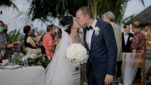 A wedding ceremony with a couple kissing, surrounded by guests. - The Kelong Trikora Resort (Bintan)