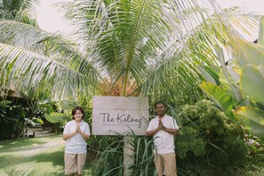 Two people standing in front of a sign that reads "The Kelong Trikora Resort Bigben Island." - The Kelong Trikora Resort (Bintan)