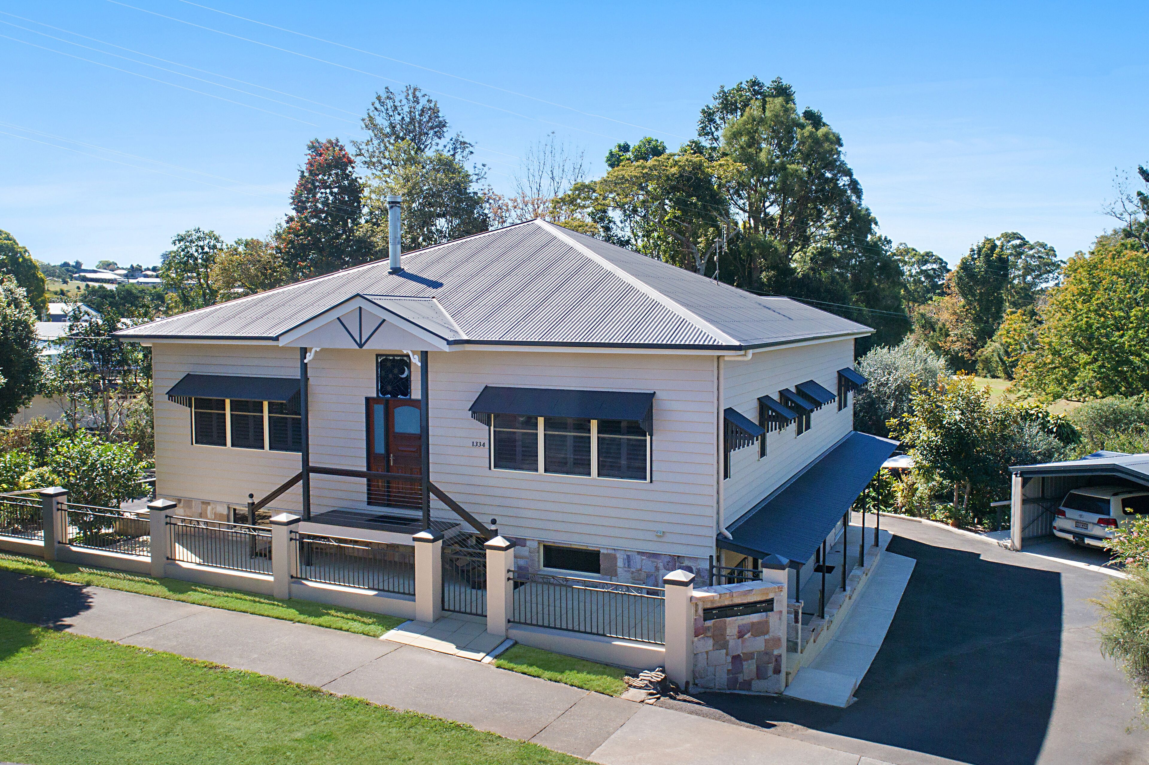 A two-story house with a front porch, a garage, and a driveway.