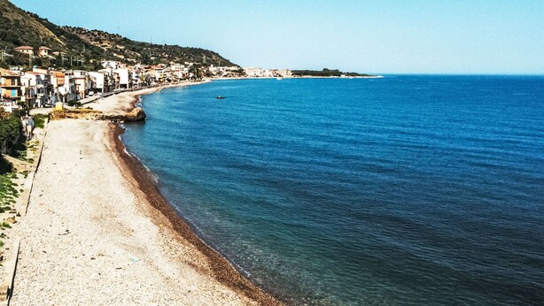 A coastal town with a beach, buildings along the shore, and a clear blue sea. - Santa Maria by Interhome (Marina di Caronia)