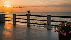 A waterfront promenade with a tiled floor and a railing with flower planters. - Santa Maria by Interhome (Marina di Caronia)