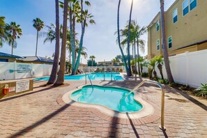 A swimming pool area with multiple pools, palm trees, and a brick pathway. - Panoramic 9th fl. Oceanfront view, parking, pool (San Diego)