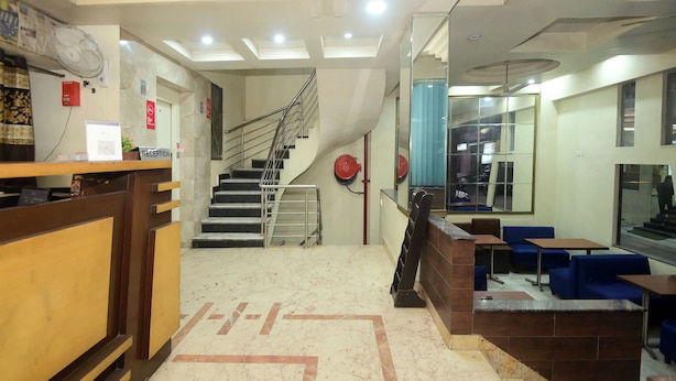 A hotel lobby with a reception desk, a staircase, and seating areas. - Hotel Ankur Palace (Jaipur)