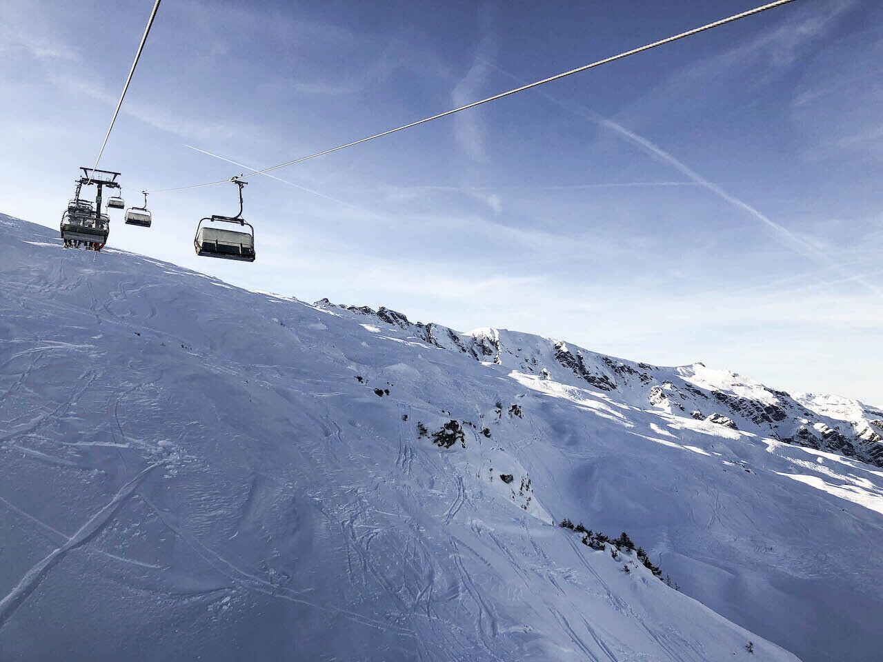 A ski lift on a snowy mountain slope.