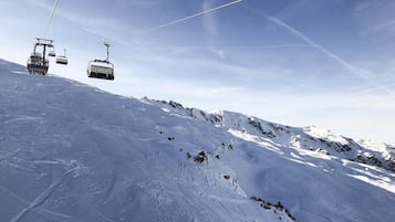 A ski lift on a snowy mountain slope.