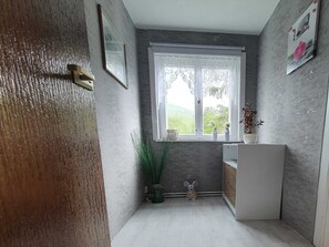 A small kitchen with a window, a sink, a cabinet, and a door. - Apartment on Staufenberg (Blankenburg (Harz))