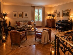 A cozy living room with a sofa, armchairs, a coffee table, and a piano.