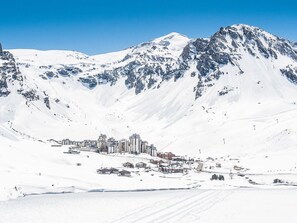 A snow-covered mountain landscape with a town nestled at its base.