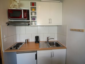 Fridge, microwave, stovetop, coffee/tea maker