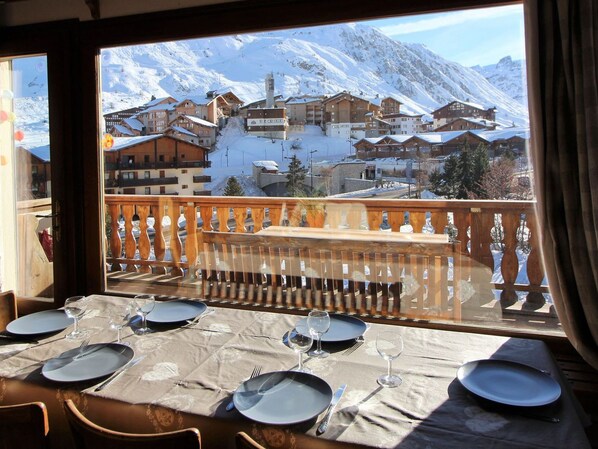 A dining table set for four with a mountain view.