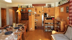 A cozy wooden interior with a dining area, a kitchen, and a living space. - Traditional Chalet in Tignes - 3 rooms, 6 people, WiFi included (Tignes)