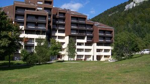 A multi-story hotel with a modern architectural design, featuring balconies and a flat roof.