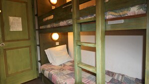 A bunk bed room with a door, a light fixture, and a bed with a patterned blanket. - Classic studio for 4, south terrace lake view (Tignes)
