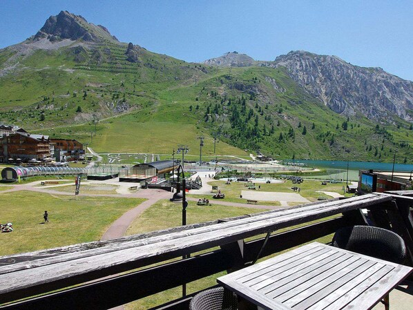 A mountain view with a restaurant and a ski lift in the foreground.