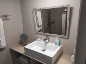 Bathtub, hair dryer, towels, toilet paper