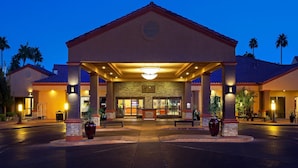 A hotel entrance with a covered walkway, palm trees, and a well-lit reception area. - Beautiful Las Vegas 2 Bdm Condo In Amazing Resort (Las Vegas)