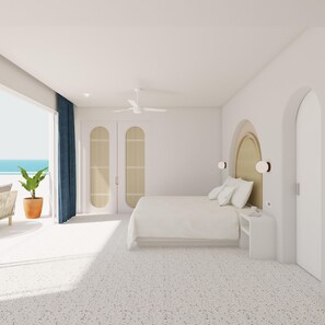 A modern bedroom with a large bed, a ceiling fan, and a view of the sea.