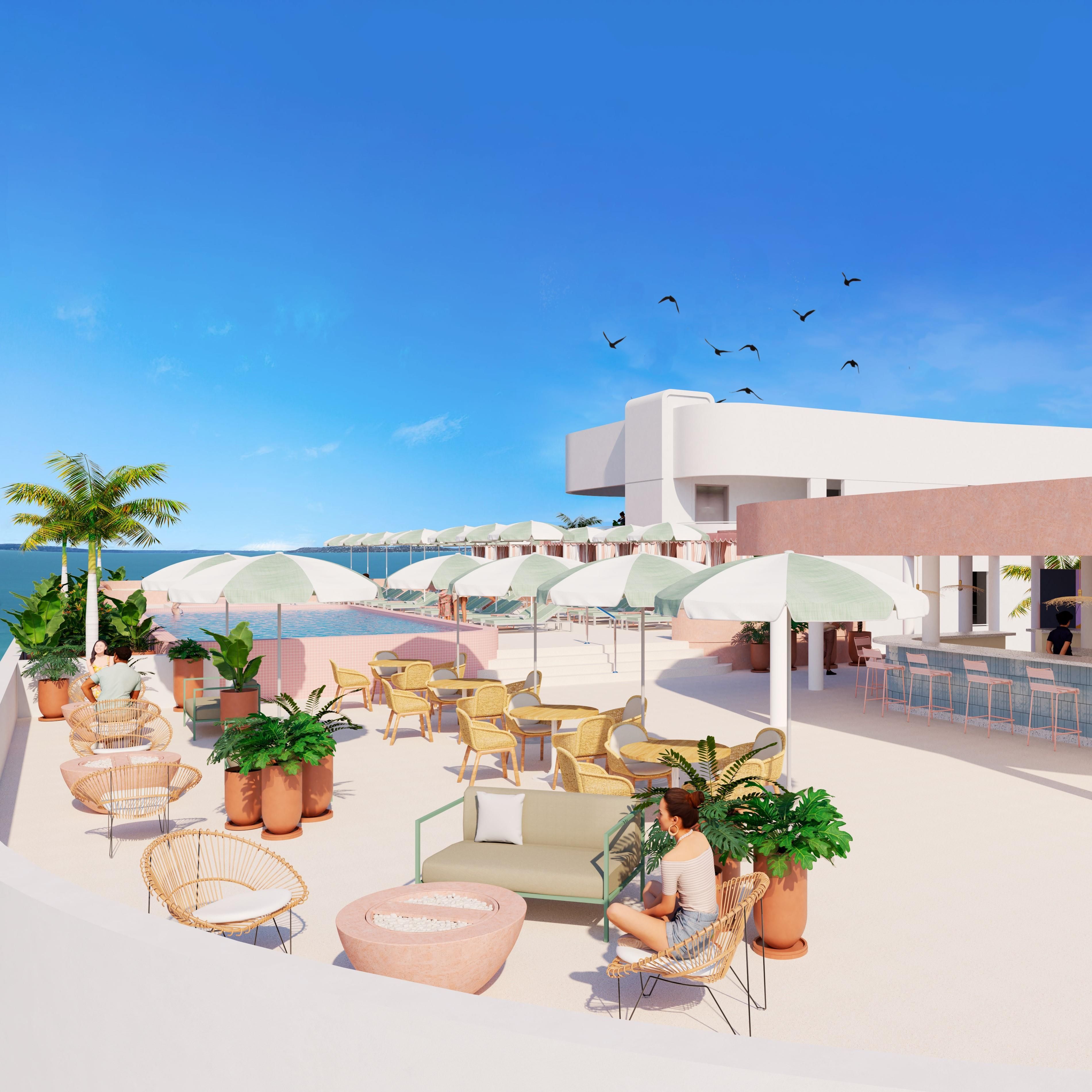 A rooftop terrace with outdoor seating, a pool, and a view of the sea.