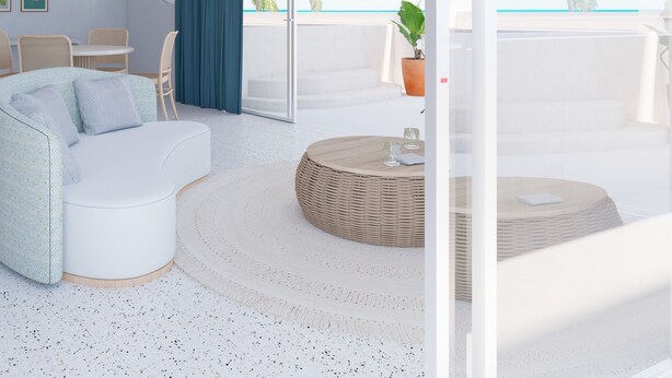 A modern living room with a white sofa, a round coffee table, and a view of the ocean through large windows. - Perla La Paz, Tapestry Collection by Hilton (La Paz)