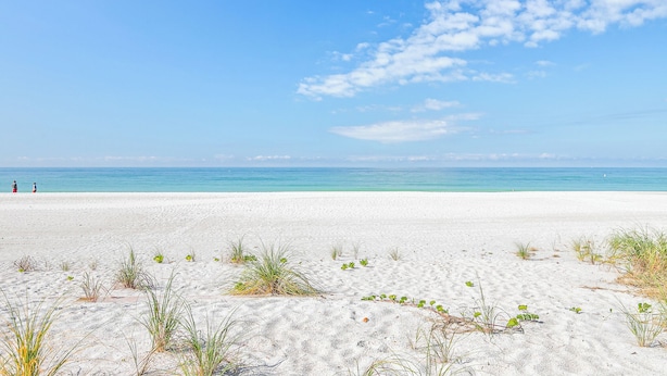 A beach with white sand and clear blue water. - Four Beach Lovers 4 · Full-Size Garden Unit · Solar · Gulf in 50 Steps (Holmes Beach)