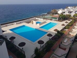 Outdoor pool, a heated pool - Apartment directly by the sea Balcony / Terrace (Costa del silencio)