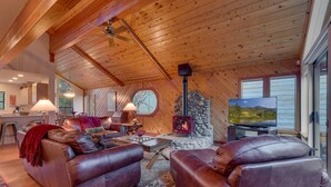 A cozy living room with leather sofas, a fireplace, and a television.