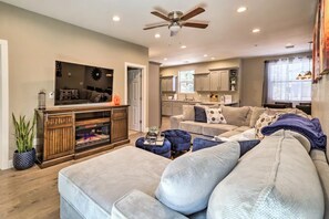 Living room with large sectional and cabinet electric fireplace