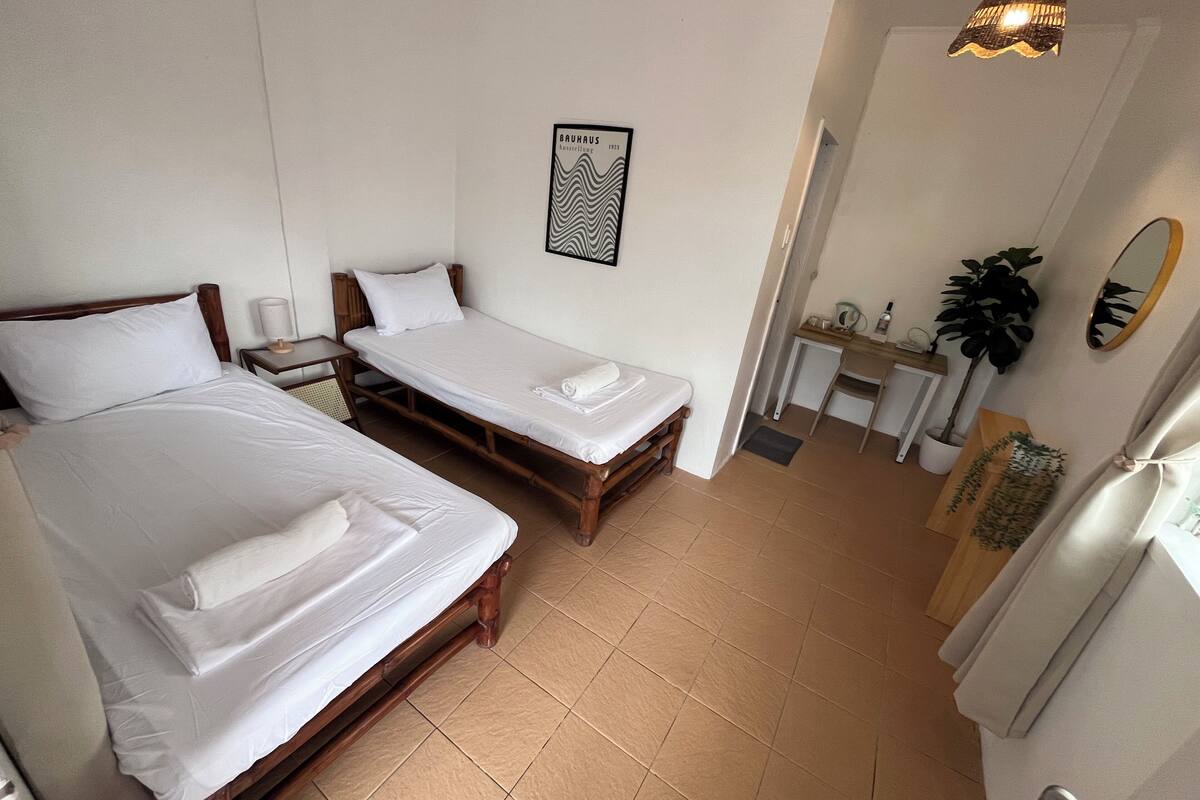 Desk, laptop workspace, bed sheets