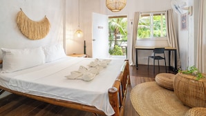 A bedroom with a bed, bedside table, and a desk with a chair.