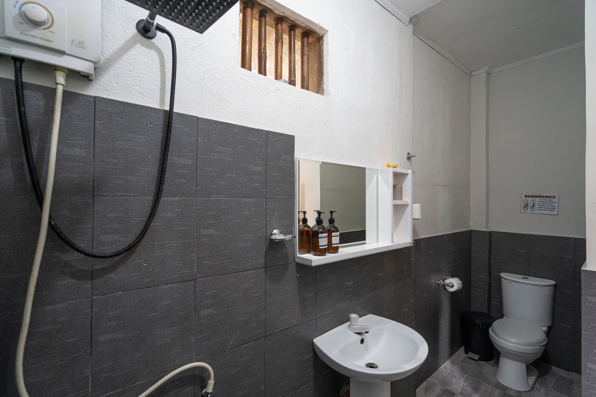 A bathroom with a sink, toilet, and a mirror above the sink.