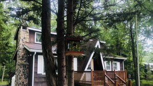 A cabin with a stone exterior, wooden deck, and a small porch. - Come and enjoy the Breath taking  Vacation cabin at  Pocono , PA (pocono lake)