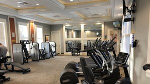A gym with treadmills, elliptical machines, and weight equipment. - Solterra Resort - is a beautiful paradise located in Davenport, near to Orlando (Davenport)