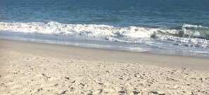 Enjoy a serene beach experience with gentle waves and endless ocean views.