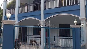 A multi-story building with a blue exterior and white trim.