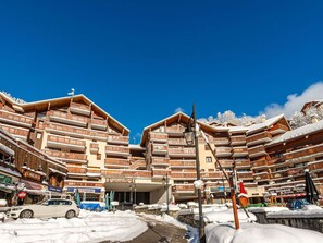 Une station de ski dotée de bâtiments en bois à plusieurs étages, d’un cinéma et d’un restaurant.