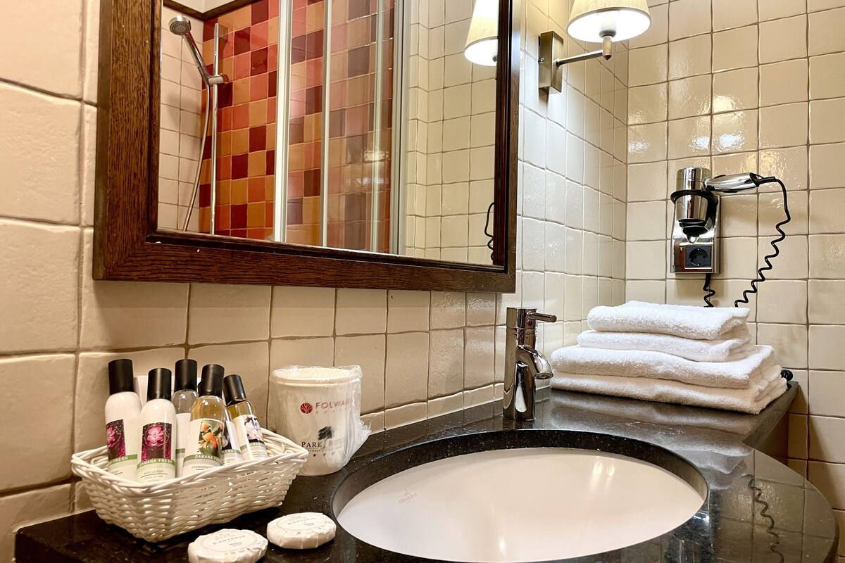 deluxe room (king-bed) | bathroom | shower, free toiletries, hair dryer, towels