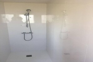 Bathtub, hair dryer, towels, toilet paper