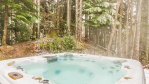 A hot tub surrounded by a forest.