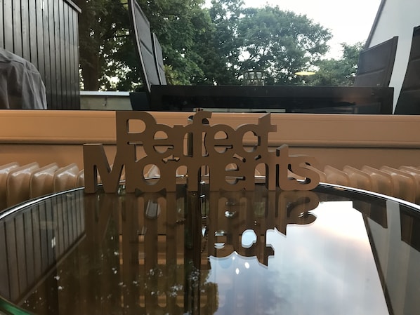 A reflective surface with a cut-out sign reading "Perfect Moments."